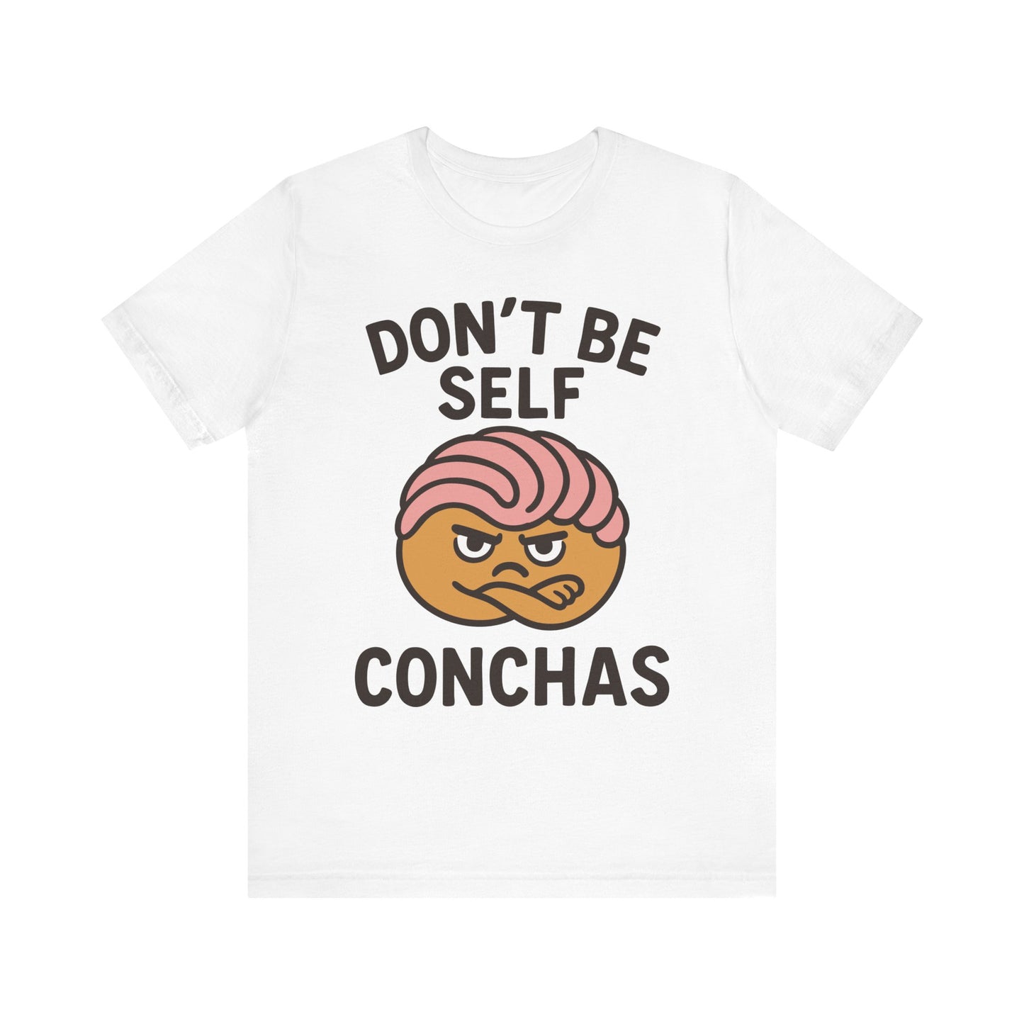 White t-shirt with 'Don’t Be Self Conchas' text and a grumpy pink concha graphic in the center