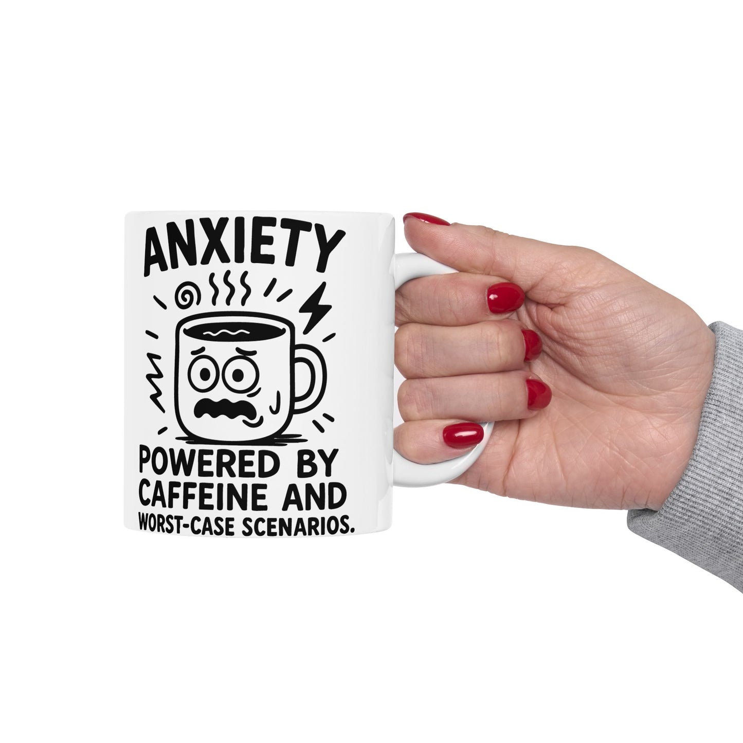 White ceramic coffee mug with black text reading "Anxiety Powered by Caffeine and Worst-Case Scenarios" and a nervous cartoon coffee cup illustration, held by a hand with red nail polish.
