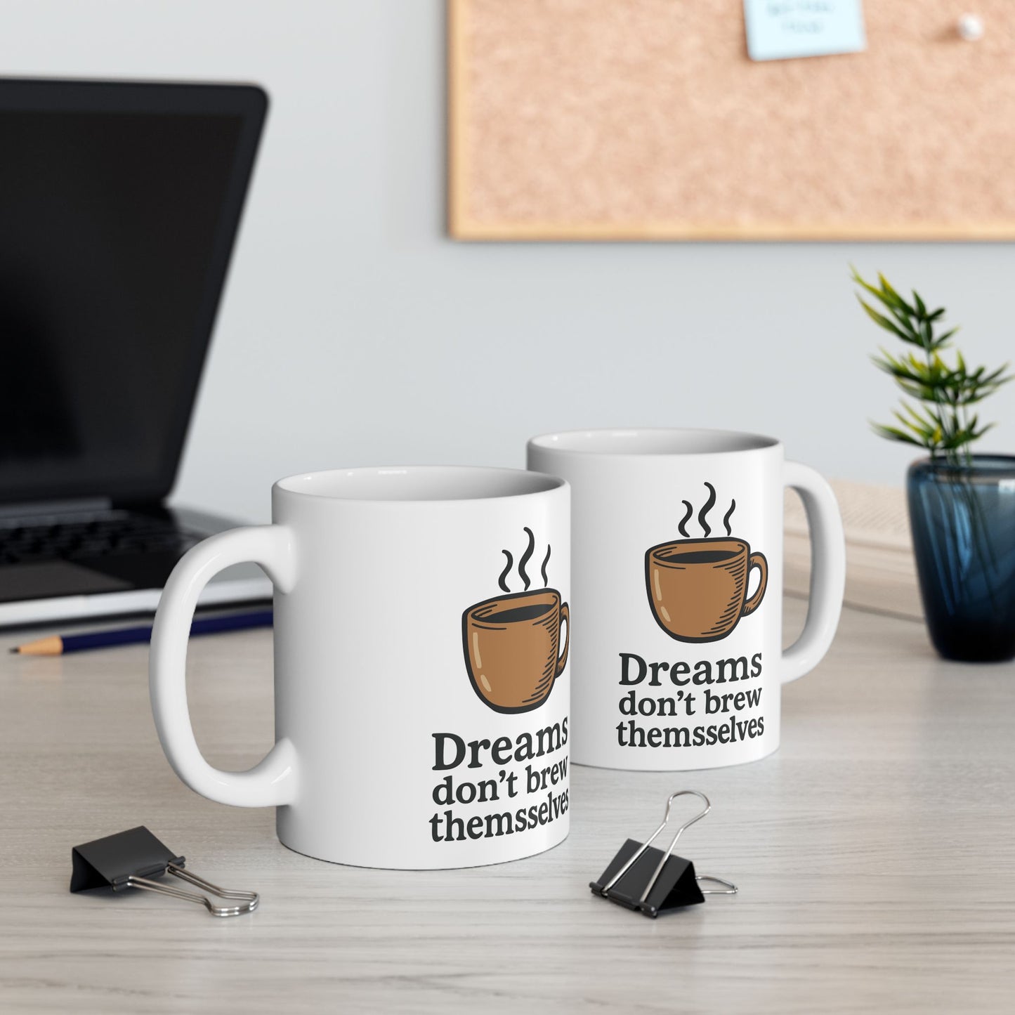 "Dreams Don’t Brew Themselves" white ceramic coffee mug with coffee cup graphic on office desk Double mugs