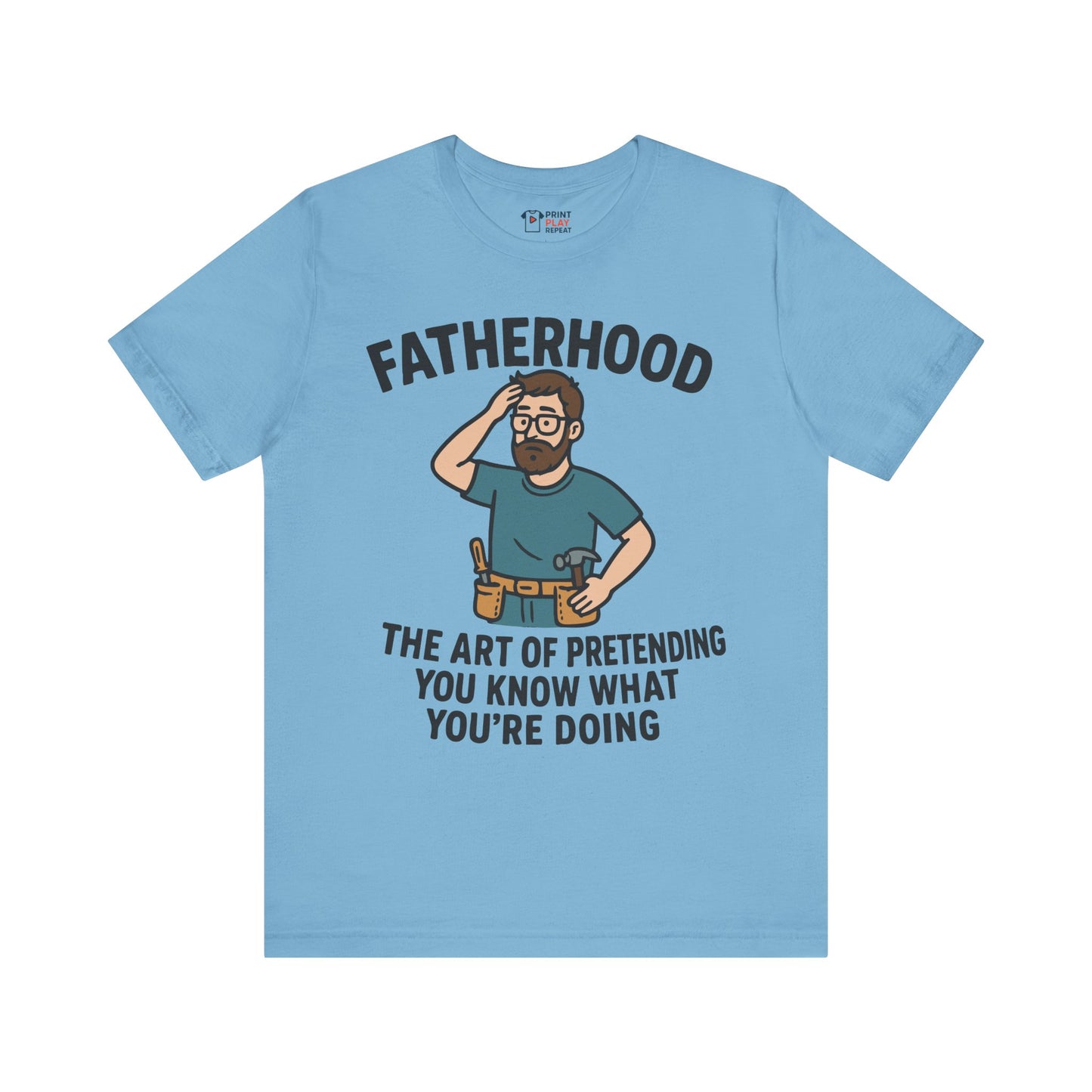 Ocean blue t-shirt with a cartoon dad in a toolbelt and the text "Fatherhood: The Art of Pretending You Know What You're Doing."