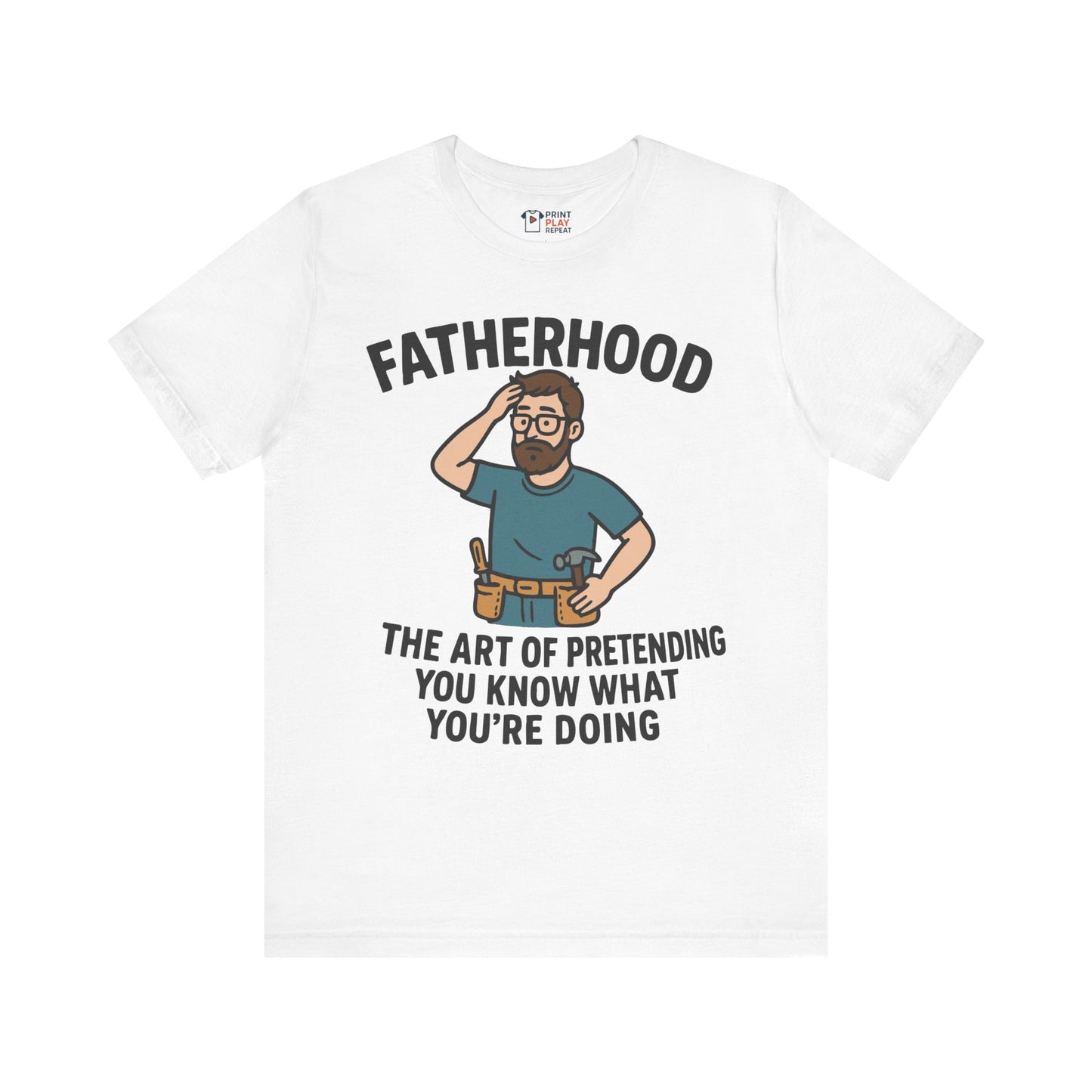 White t-shirt with bold black text reading "Fatherhood: The Art of Pretending You Know What You're Doing" and a cartoon dad graphic.