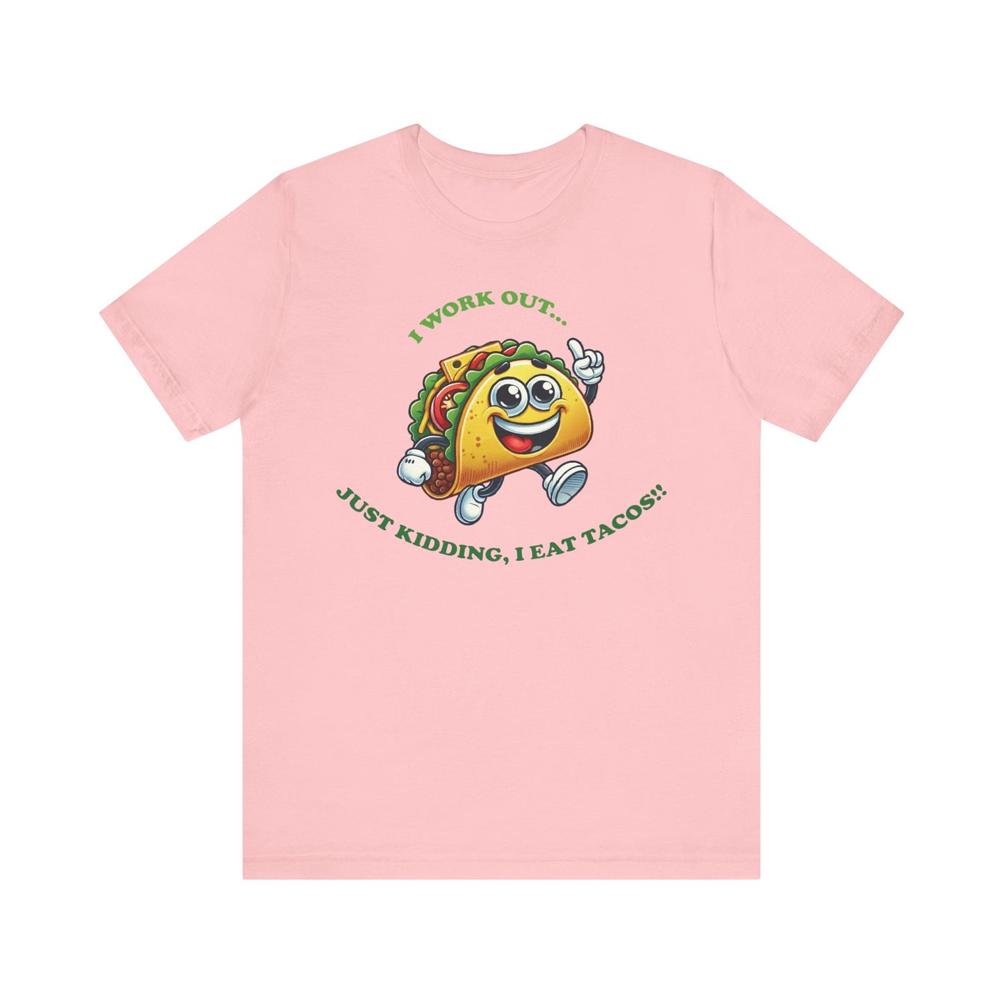 Pink t-shirt with an adorable cartoon taco wearing sneakers, with the humorous text "I WORK OUT... JUST KIDDING, I EAT TACOS!!" in green letters.
