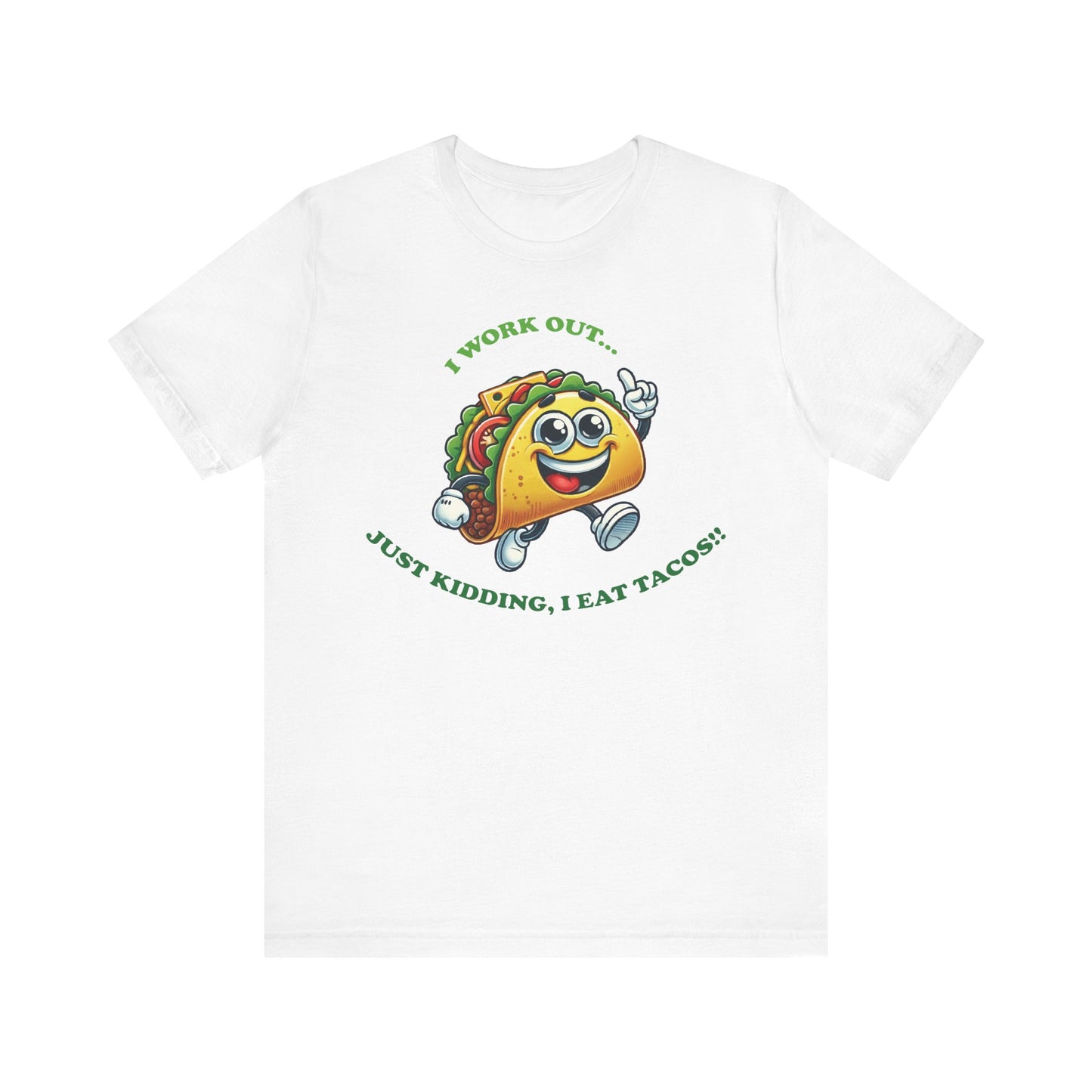 White t-shirt featuring a fun cartoon taco character in running shoes, with the caption "I WORK OUT... JUST KIDDING, I EAT TACOS!!" in green lettering.