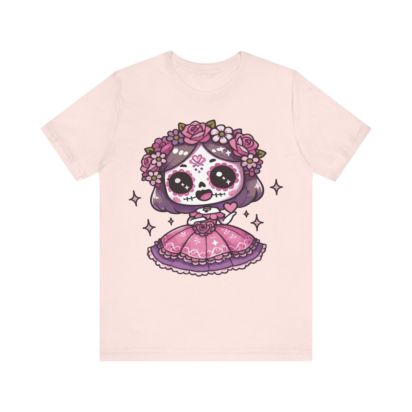 Soft pink t-shirt with adorable kawaii sugar skull girl, purple hair, pink folk dress, floral crown of roses, and sparkles.