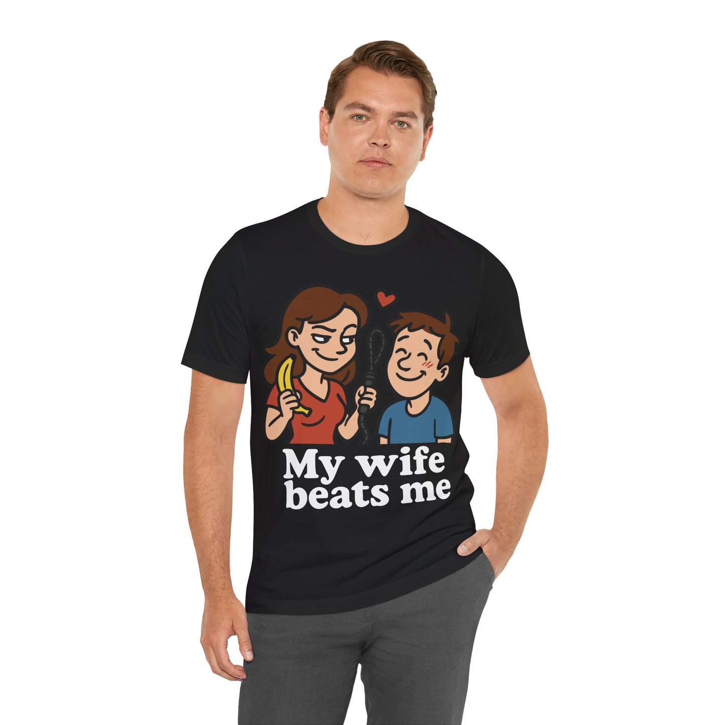 Black t-shirt featuring a cartoon of a smiling wife holding a banana and whip next to her husband, with the bold text "My Wife Beats Me" and a red heart above them.