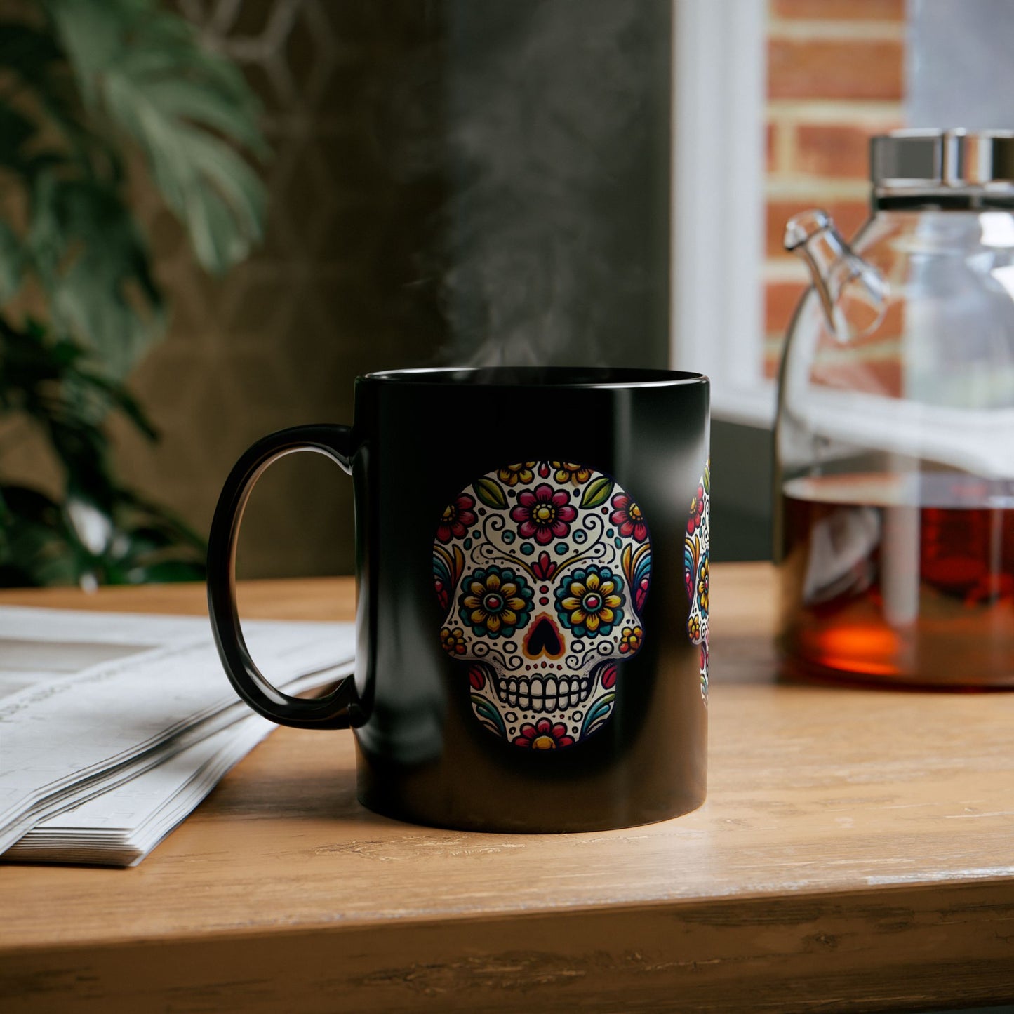 Black ceramic coffee mug with a vibrant Day of the Dead sugar skull design featuring multicolored floral and geometric patterns.