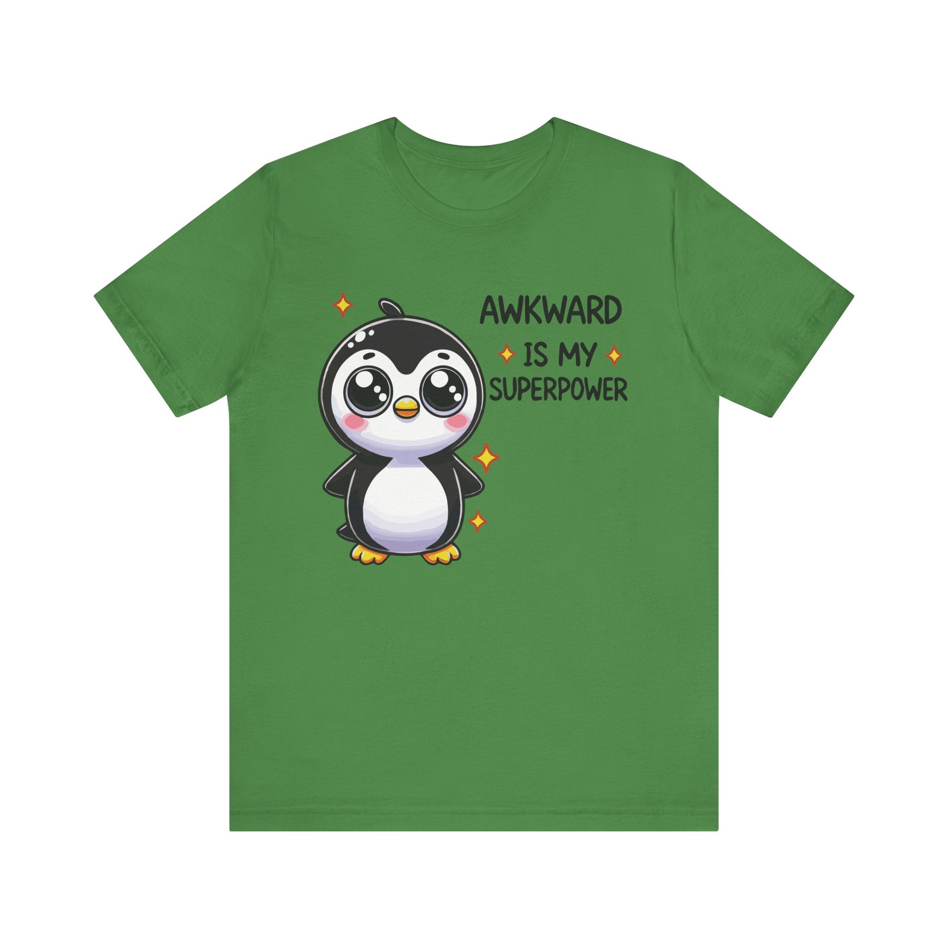 Leaf green t-shirt with a happy cartoon penguin and quirky text that reads "Awkward Is My Superpower" in a bold, playful font.
