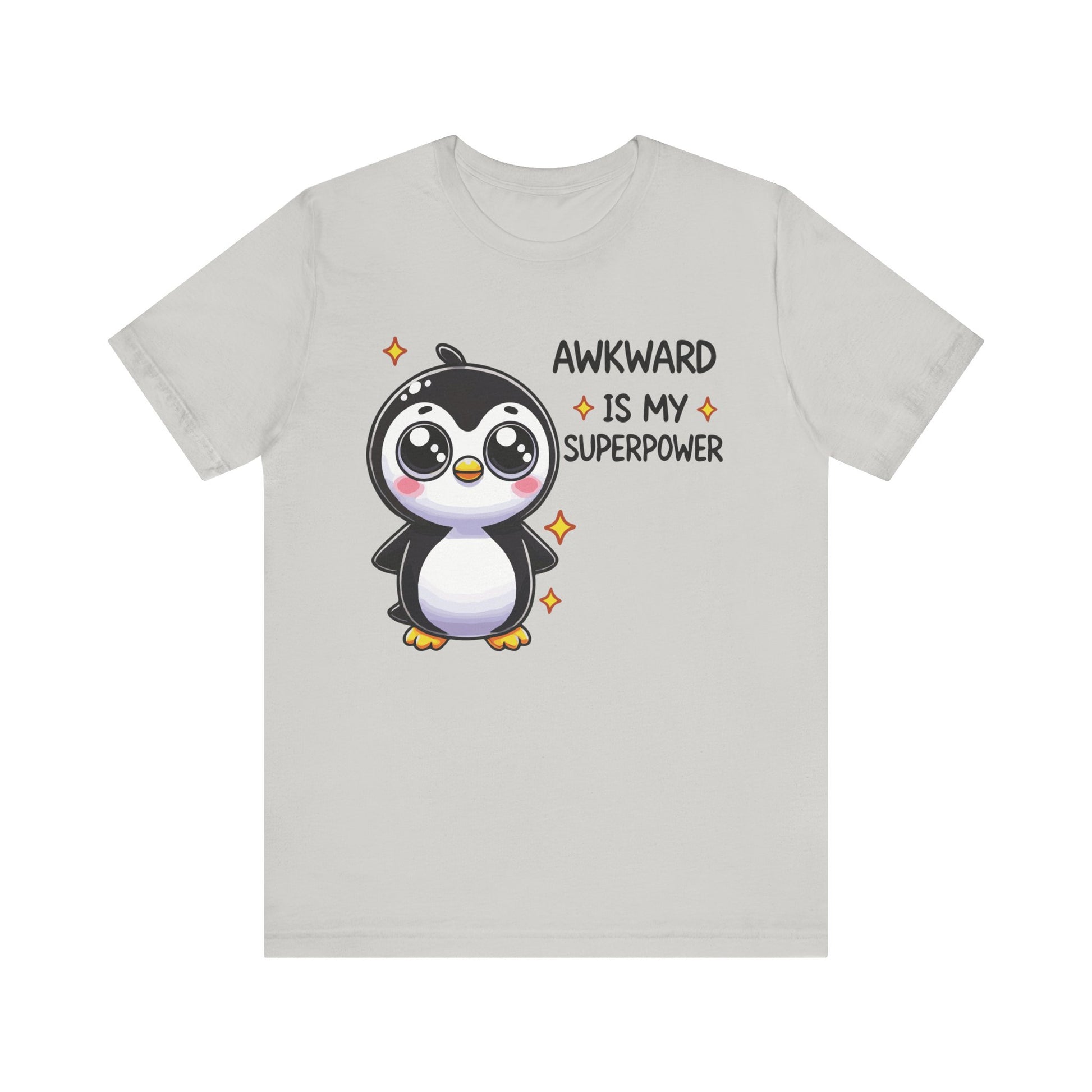 Silver t-shirt with a kawaii-style penguin surrounded by sparkles and the funny phrase "Awkward Is My Superpower."
