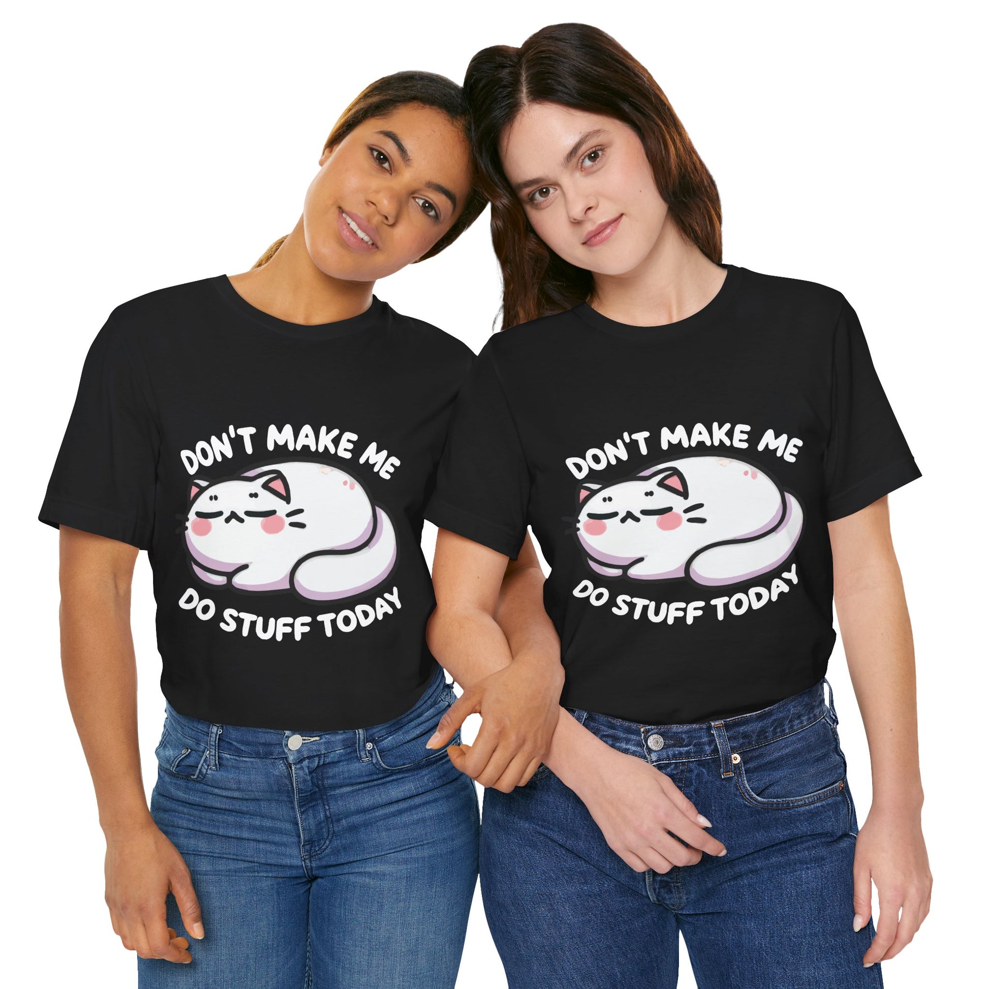 Two women wearing black t-shirts featuring a cute lazy cartoon cat lying down with blushing cheeks and the phrase "Don't Make Me Do Stuff Today" in bold white text.

