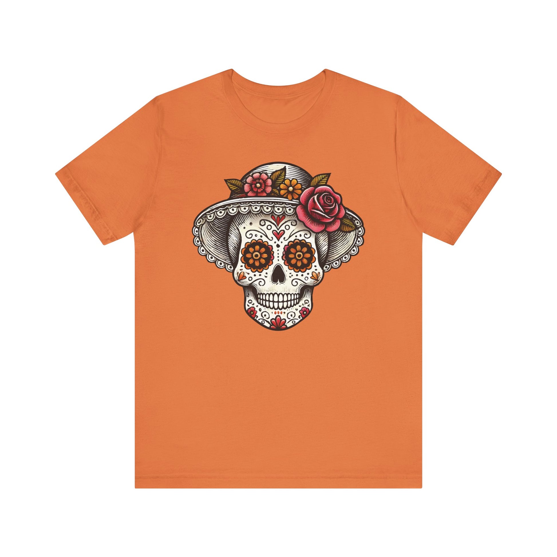 Burnt orange t-shirt with an intricate Catrina skull wearing a lace-trimmed hat and roses, inspired by Mexican traditions.
