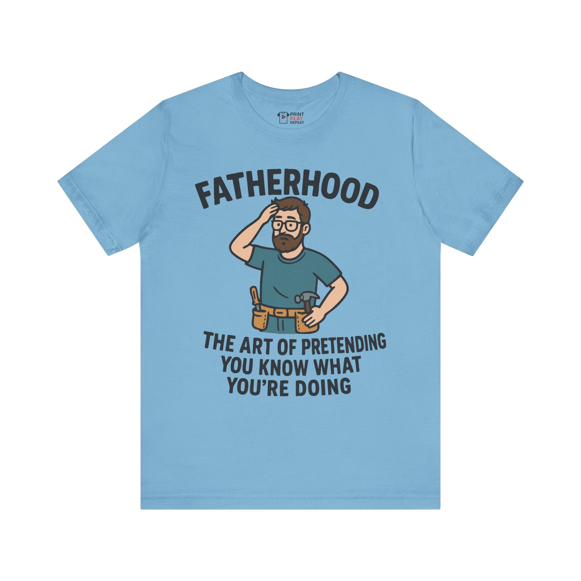 Ocean blue t-shirt with a cartoon dad in a toolbelt and the text "Fatherhood: The Art of Pretending You Know What You're Doing."
