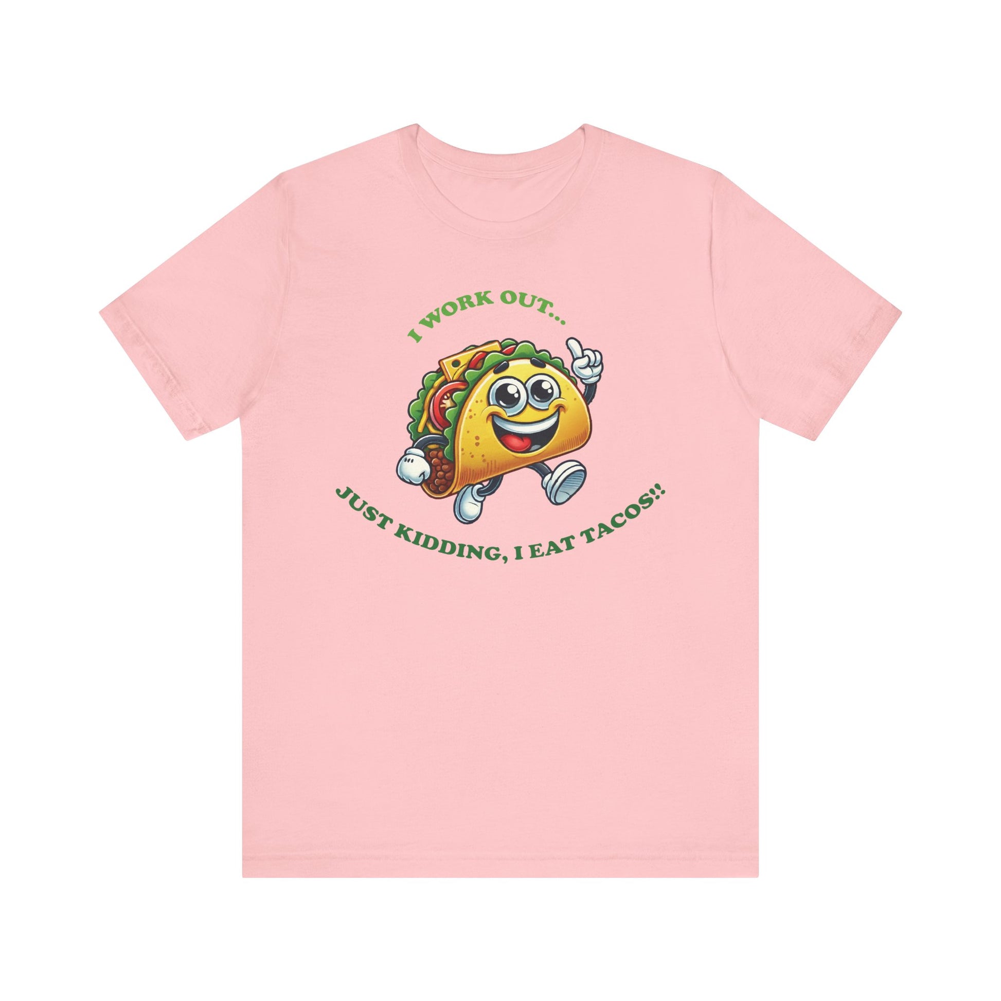Pink t-shirt with an adorable cartoon taco wearing sneakers, with the humorous text "I WORK OUT... JUST KIDDING, I EAT TACOS!!" in green letters.

