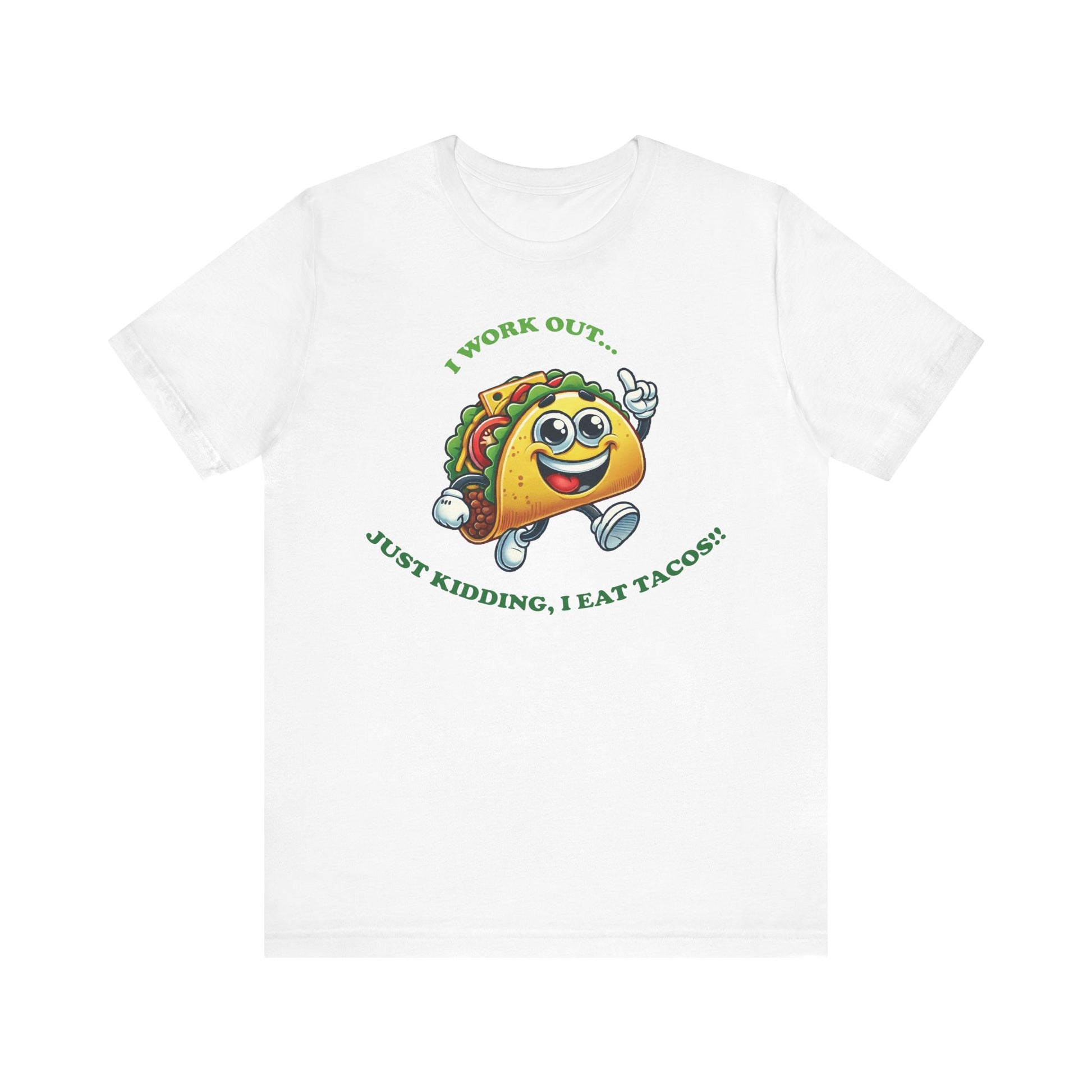 White t-shirt featuring a fun cartoon taco character in running shoes, with the caption "I WORK OUT... JUST KIDDING, I EAT TACOS!!" in green lettering.

