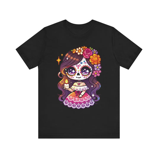 Black t-shirt featuring an adorable kawaii sugar skull girl holding a glowing candle, with flowing brown hair, colorful floral crown, and pink Mexican dress. Cute Día de los Muertos theme.

