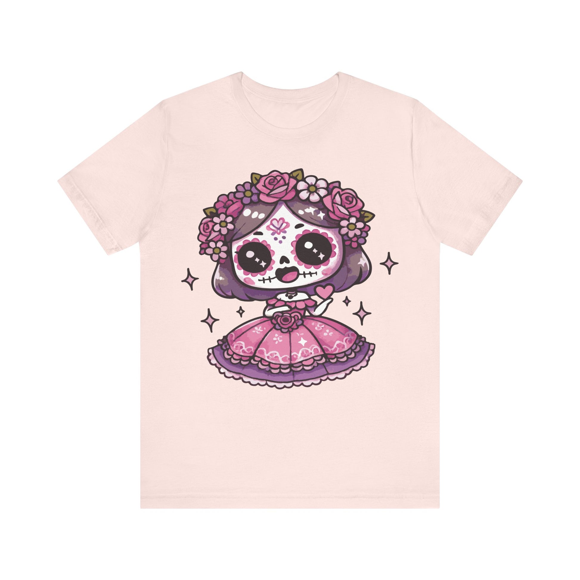 Soft pink t-shirt with adorable kawaii sugar skull girl, purple hair, pink folk dress, floral crown of roses, and sparkles.


